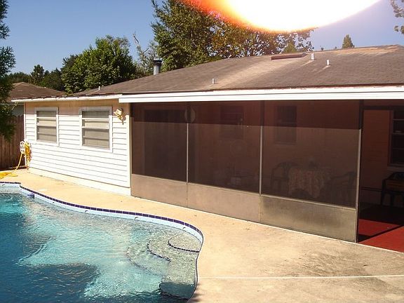Rear of house with pool and screened patio
