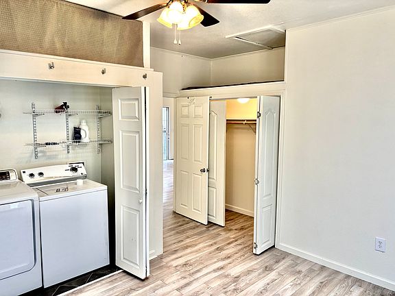 View of the office showing the washer/dryer and closet with overhead storage space.