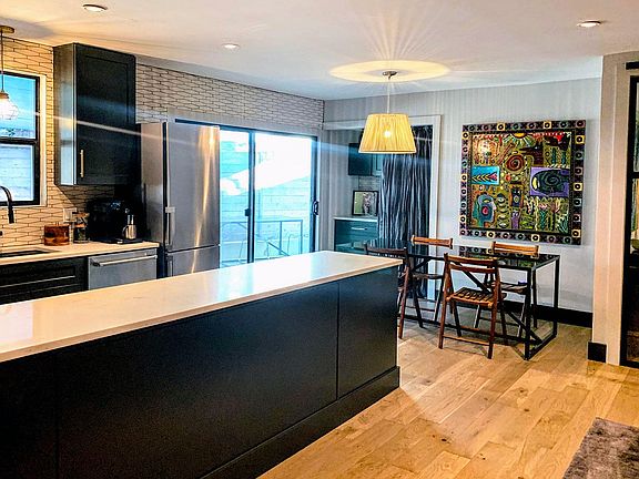 Dining View w/Coffee Cabinet and Stacked Washer/Dryer behind Curtains