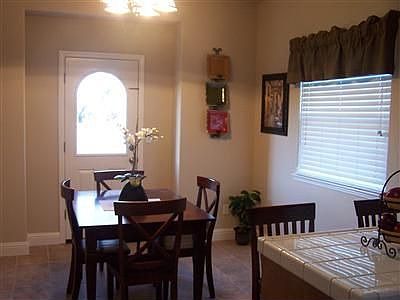 Spacious dining area connected to the kitchen with access to front yard.
