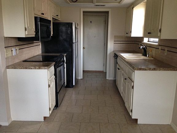 Tiled kitchen floor with updated counters and backsplash