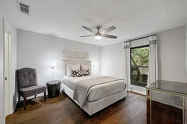 Guest bedroom on 2nd floor, large enough for kind or queen bed. Hardwood tile floors and custom drapery and black out shades.