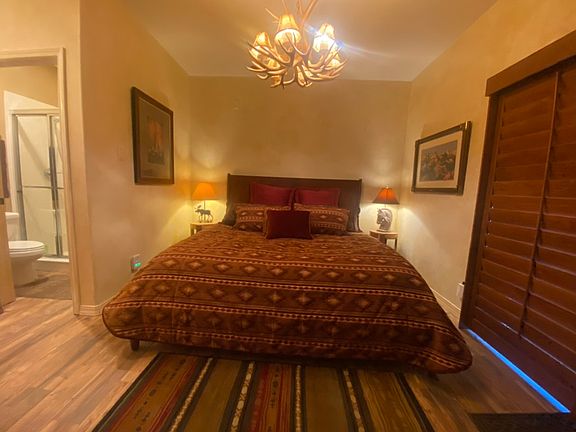 King en suite on first floor with vanity separated from commode and shower
