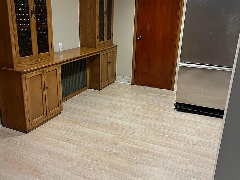 Lower-level built-ins showing door to bedroom; room for a dining table; cabinets provide extra storage