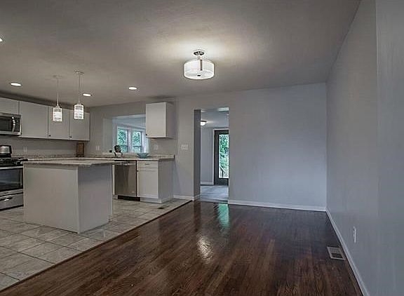 New open Kitchen! Dining Room with original hardwood. New Lighting, Electric, Paint, Plumbing and Windows.