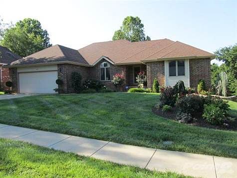 Front view of home with a beautifully landscaped yard.