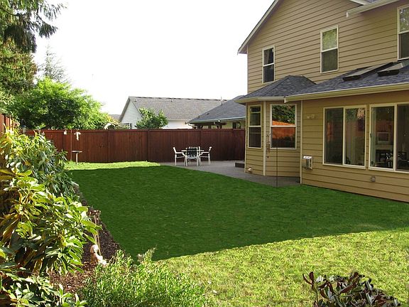 Large fenced backyard with wrap around aggregate patio!