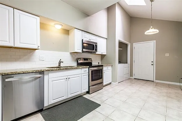 Large and open kitchen. Stainless steel appliances.