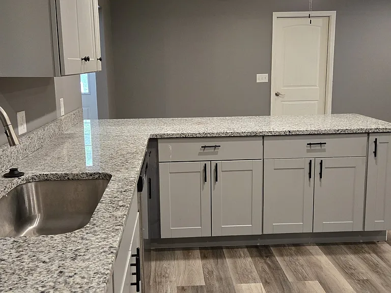 Kitchen sink area looking into dining area