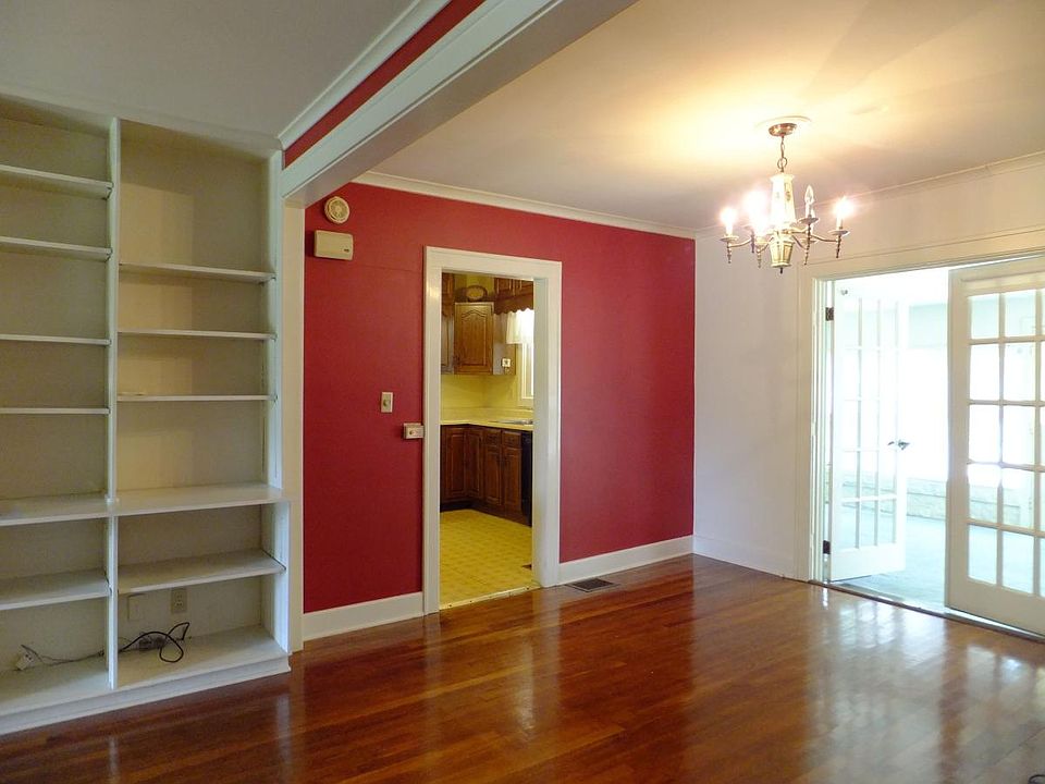 View from living room showing built in book shelves, kitchen