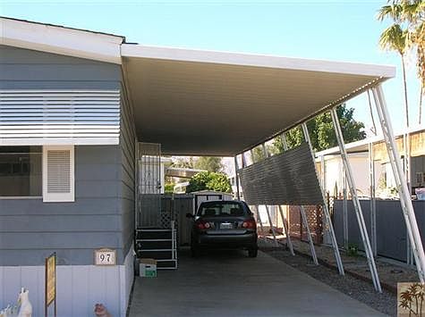 North side of home with carport for 2 or 3 cars & shed in rear.