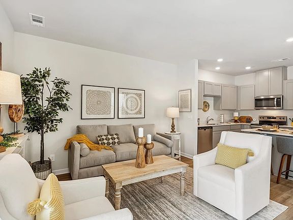 Imagine entertaining in your open bright livingroom that opens to your kitchen. Photo staged to show you the possibilities!