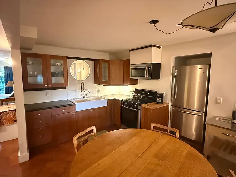 Full-size refrigerator, large table with four chairs