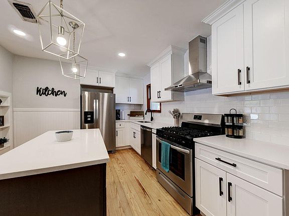 Kitchen w/ quartz countertops and gas stove w/ spice rack if you love cooking. Microwave is in island :)
