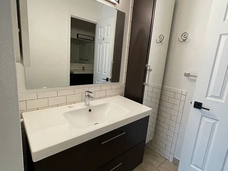 Sink and cabinet en-suite for master bedroom.