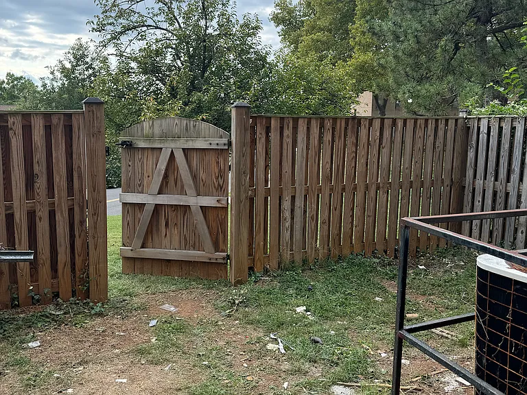 Fenced back yard area and exit gate.