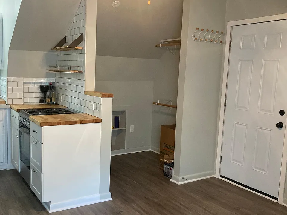 Walk-in Closet w/ 2 hanging racks. Closet has built in storage and room for chest of drawers