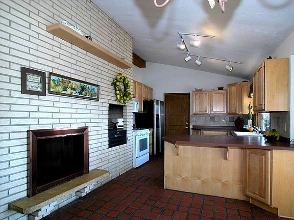 View of Kitchen and Wood Burning Fireplace