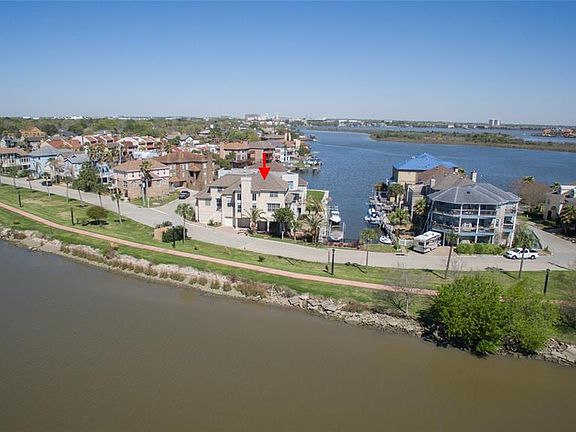 AWESOME CORNER LOT OFFERS VIEWS OF BOTH CLEAR LAKE AND CLEAR CREEK. EVERY ROOM ENJOYS A WATER VIEW