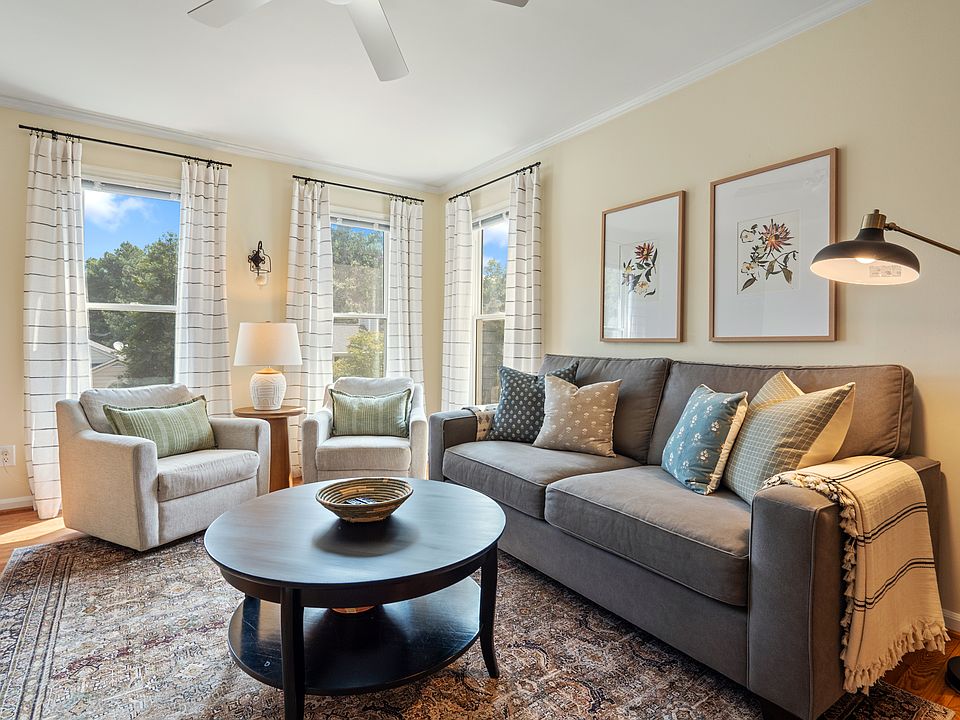 The living room is spacious, filled with natural light, and offers plenty of comfortable seating.
