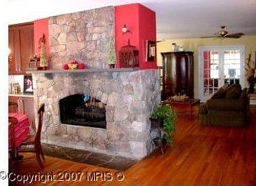 Stone fire place (two way) separates kitchen from family room
