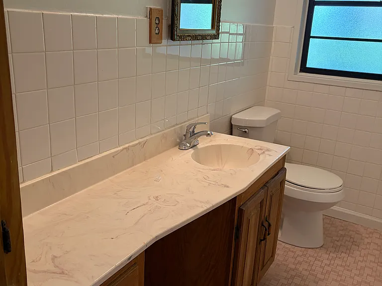 Hall bathroom with tile floor