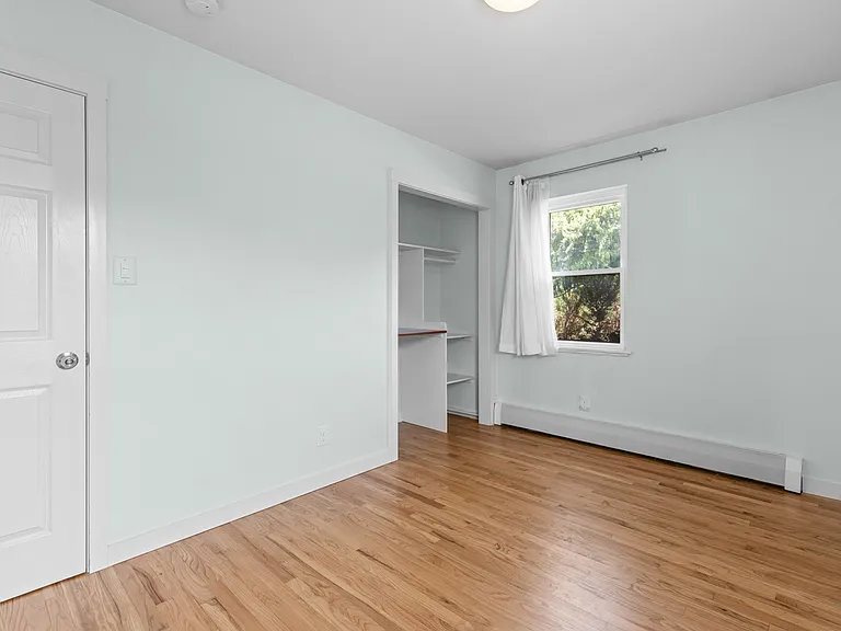 Storage is plentiful in the third bedroom, with a traditional closet plus additional built-in shelving and hanging space.