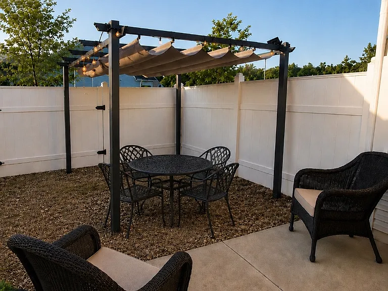 Private backyard with a 6-foot vinyl privacy fence and pergola, perfect for added shade and outdoor entertaining. Lawncare included