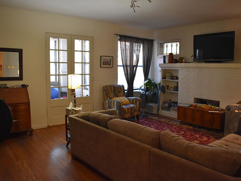 Large living room with, french doors, decorative fireplace, 