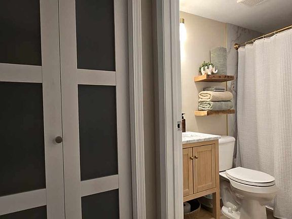 Private en suite master bath featuring a tub/shower combo, ample storage, and a bright, functional layout.