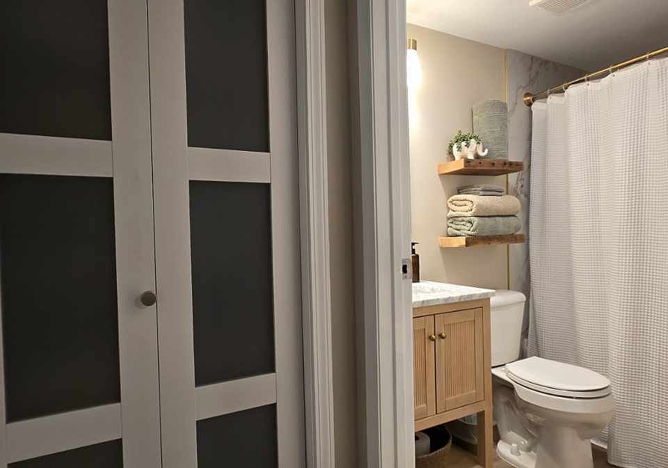 Private en suite master bath featuring a tub/shower combo, ample storage, and a bright, functional layout.