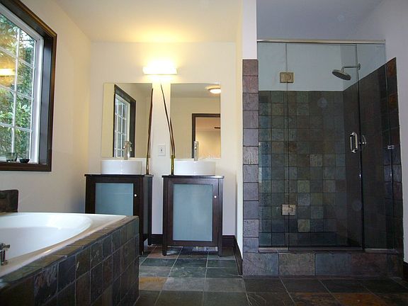 Master bath features slate tile, designer vanities, whirlpool 
