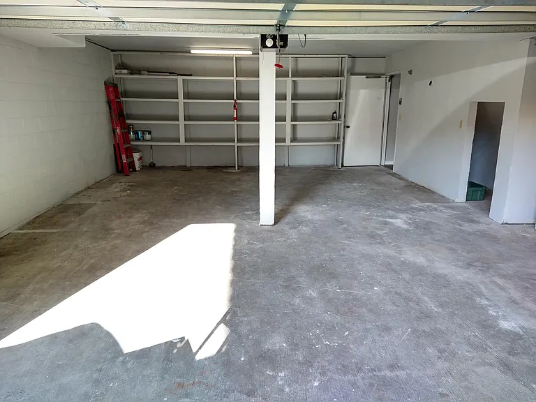 Huge garage with built-in shelves.