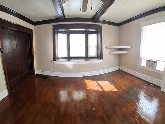 View from the doorway into the room. There is a large bay window facing east.