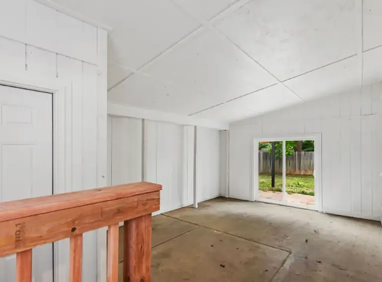 Large breezeway between garage and house for hobbies, storage, or extra space.