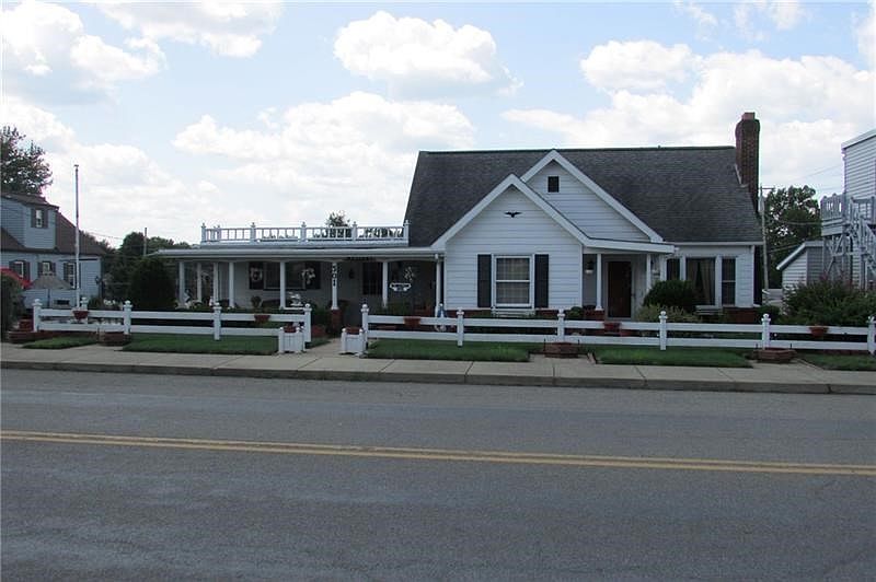 Exterior front of this beautiful cape cod.  Parking on the street and behind the house off the alley.
