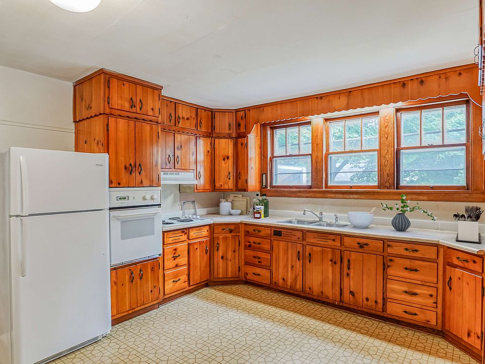 Spacious kitchen large windows wood cabinets
