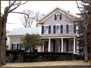 Outstanding antique Greek Revival home surrounded by mature landscaping 