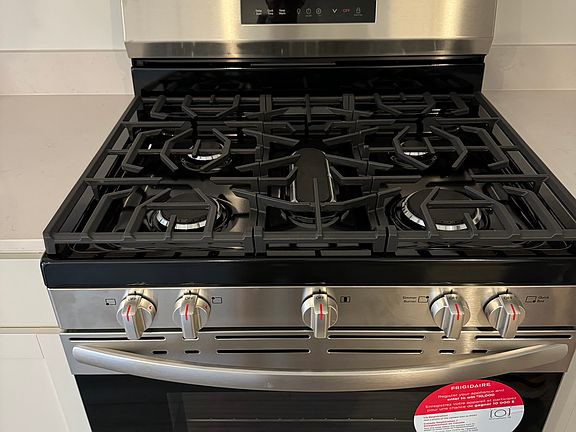 Deluxe gas stove with 5th burner for a griddle.