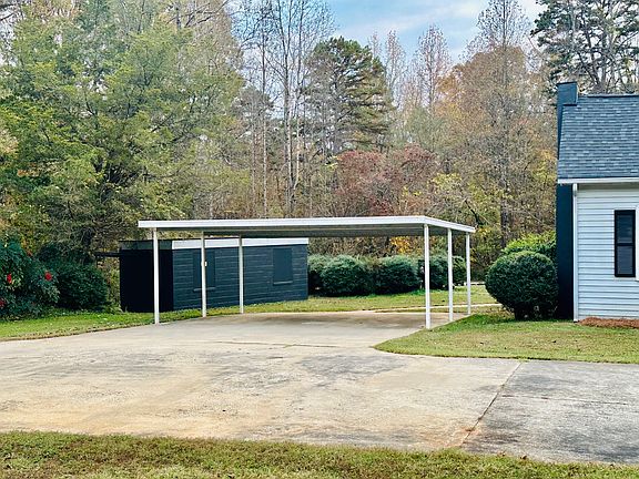 Two car covered carport and storage building