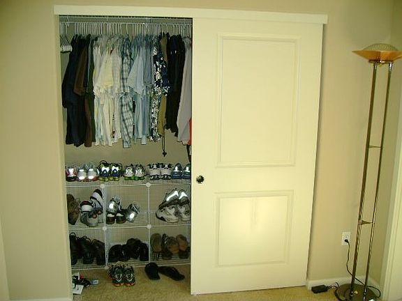 Deep master closet w/built in shelving on side