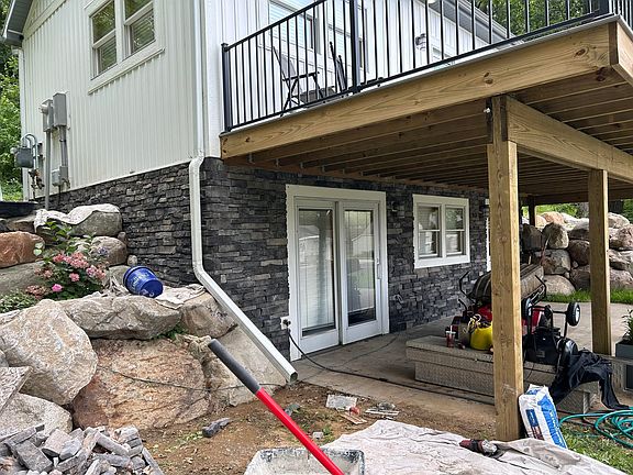 Front of house after the stone work was done on the bottom half.
