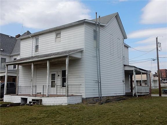 a view of the back of the home, you can access the back porch through the kitchen of the lower unit
