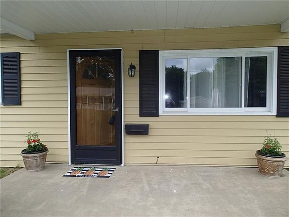 Cozy covered front porch to sit and relax!
