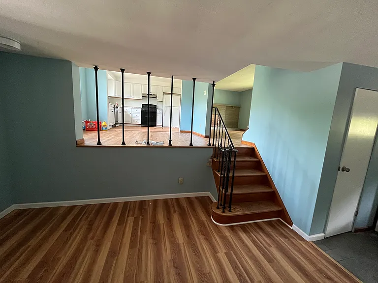 View from family room to kitchen and living room level.
