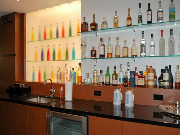 Wet bar in the lower level is adjacent to a pool table area, entertainment room and cinema room.