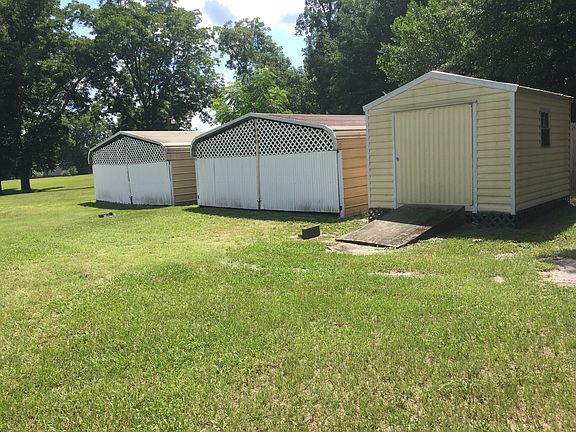 Two enclosed carports & shed