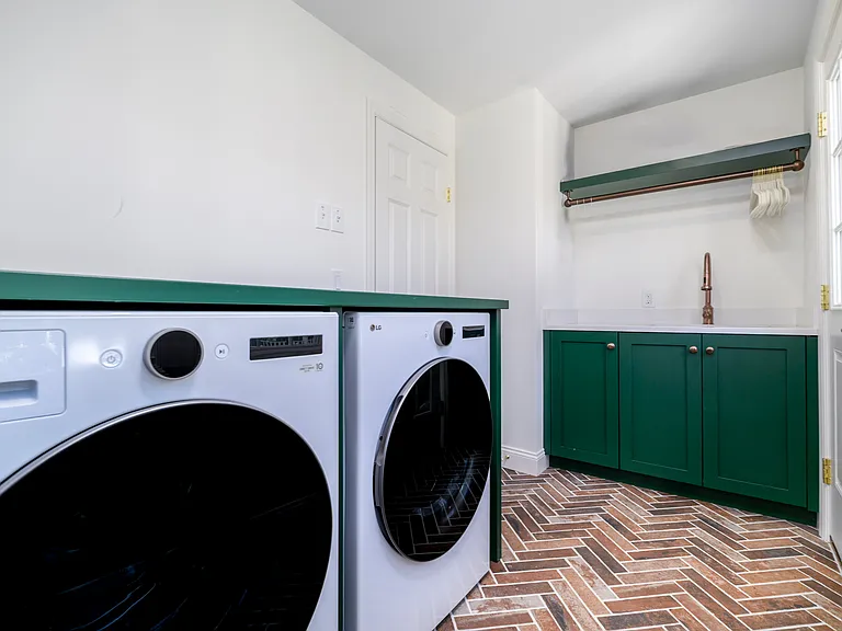 Large Laundry with sink, room to iron and access to deck
