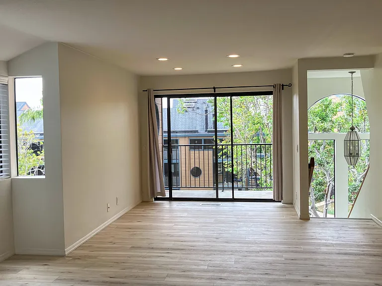 Living, dining, balcony stairway to lower level. Fabulous natural light.