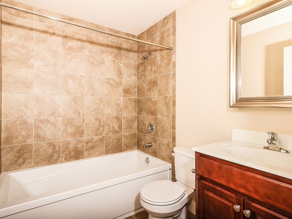 Six foot bathtubs with tiled walls.